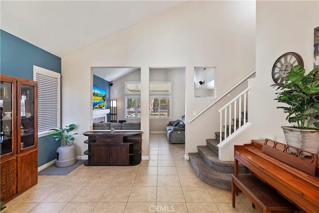 tiled foyer with lofted ceiling