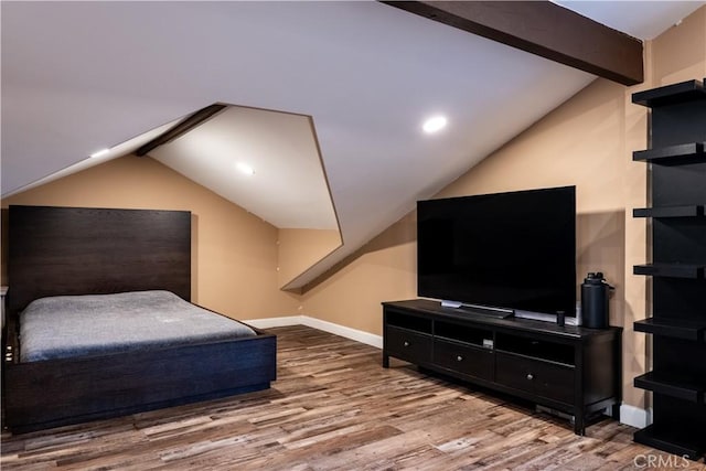 bedroom with hardwood / wood-style floors and lofted ceiling