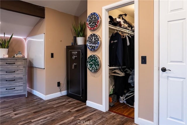 bedroom with dark wood-type flooring and a closet