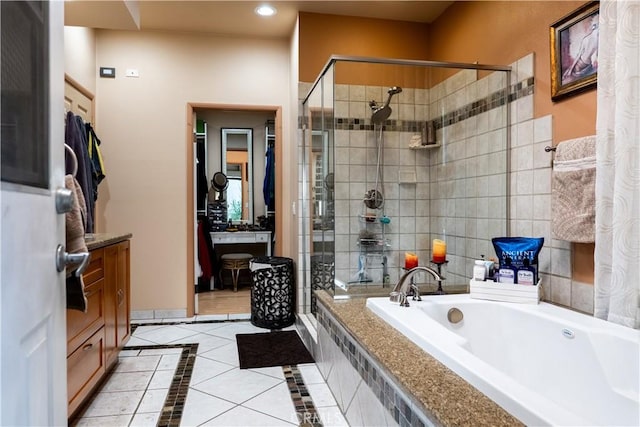 bathroom featuring tile patterned flooring, vanity, and independent shower and bath