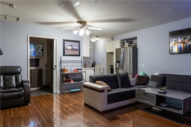 living room with ceiling fan, dark hardwood / wood-style flooring, and sink