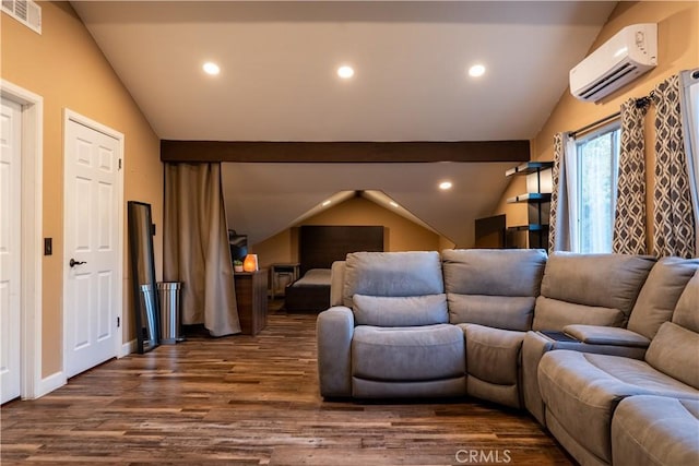 cinema room featuring dark hardwood / wood-style flooring, a wall unit AC, and vaulted ceiling