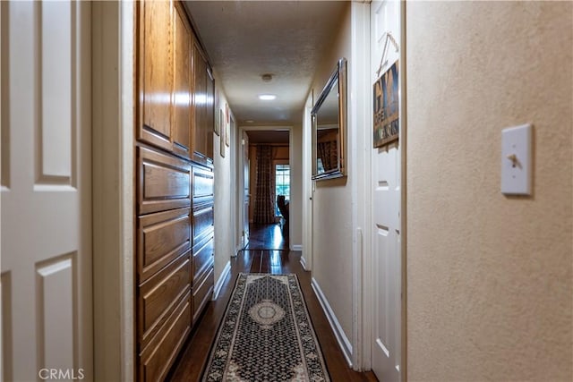 hallway with dark wood-type flooring