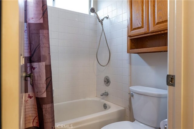 bathroom featuring shower / bathtub combination with curtain and toilet