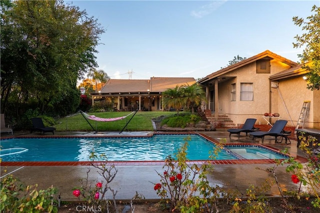 view of pool with a yard