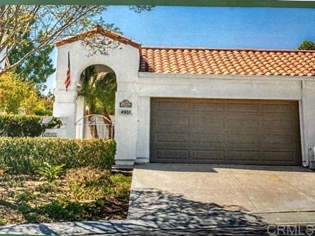 mediterranean / spanish-style house with a garage