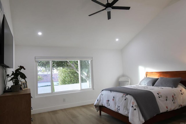 bedroom featuring hardwood / wood-style flooring, ceiling fan, and lofted ceiling