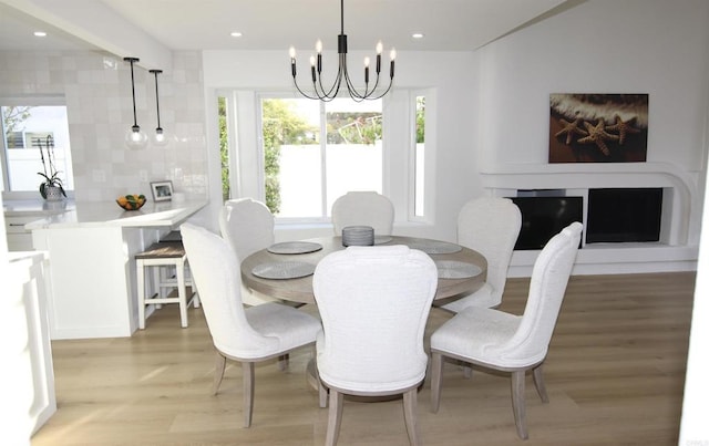 dining room featuring an inviting chandelier and light hardwood / wood-style flooring