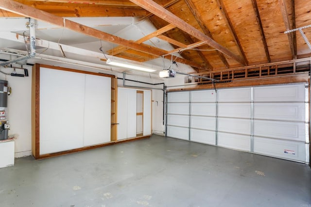 garage featuring gas water heater and a garage door opener