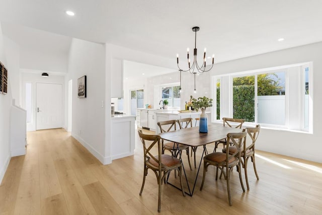 dining room with light wood-style floors, baseboards, a chandelier, and recessed lighting