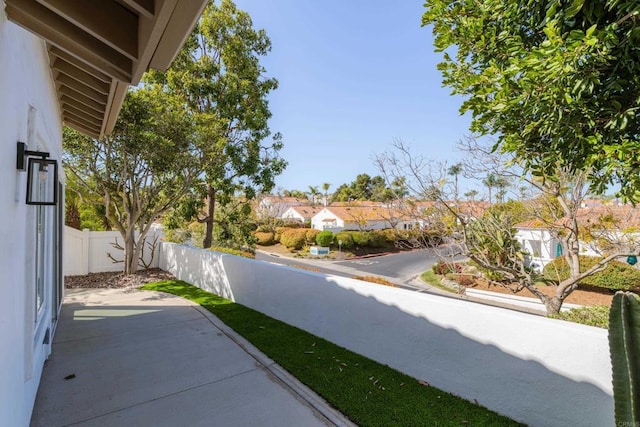 view of patio / terrace with a residential view and fence