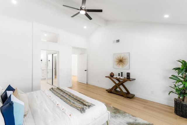 bedroom with connected bathroom, visible vents, baseboards, light wood-type flooring, and beam ceiling