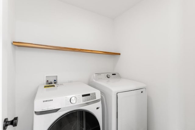 washroom featuring laundry area and separate washer and dryer