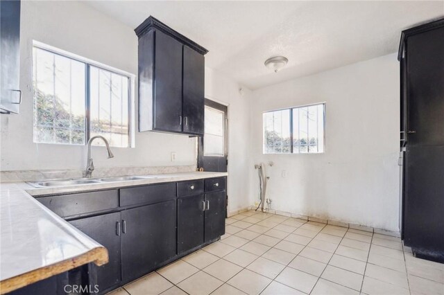 kitchen with light tile patterned floors and sink