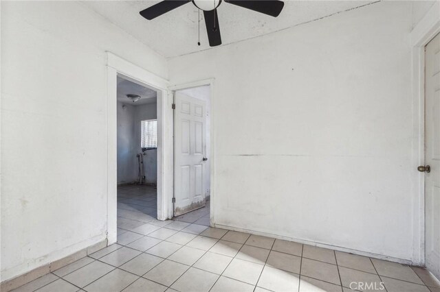 unfurnished room featuring ceiling fan and light tile patterned flooring