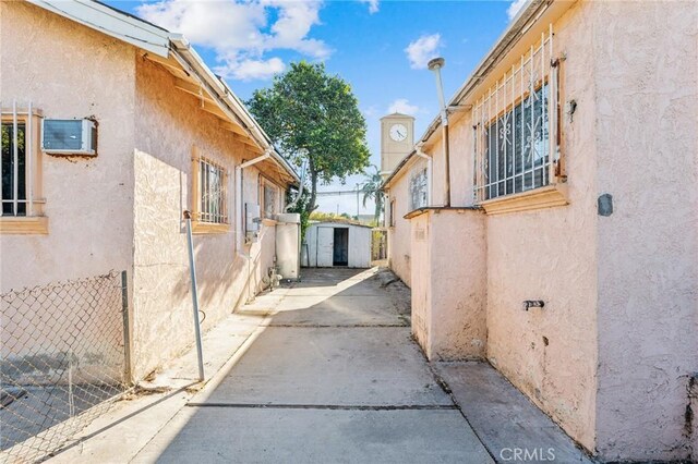 view of side of property with a storage unit