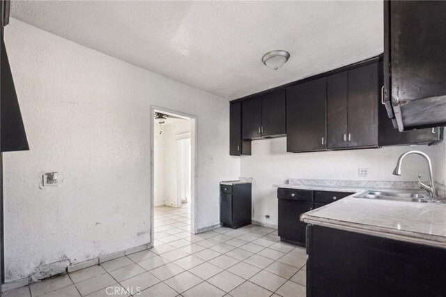 kitchen featuring sink and light tile patterned flooring