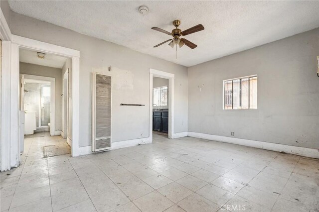 spare room featuring ceiling fan and a textured ceiling