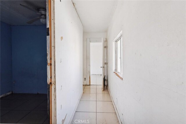 hall featuring light tile patterned floors