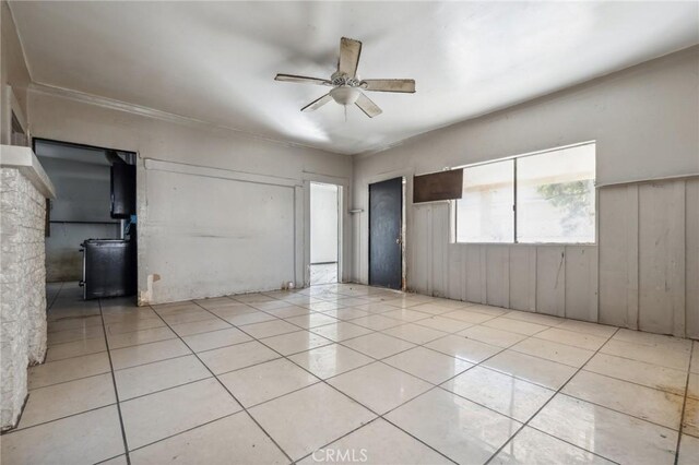 tiled empty room with ceiling fan