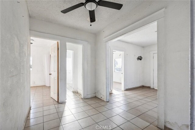 interior space with light tile patterned floors and a textured ceiling