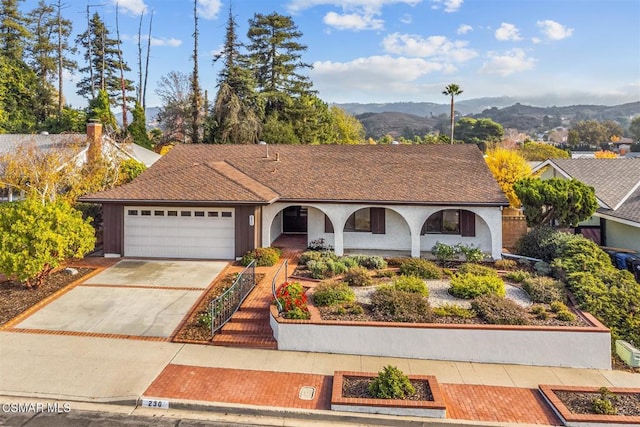 ranch-style house with a mountain view and a garage