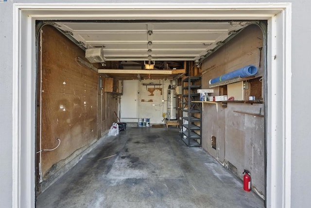 garage featuring strapped water heater and a garage door opener