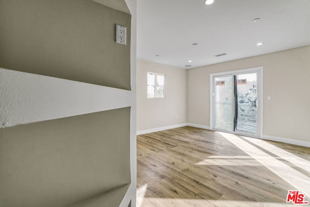 spare room with light wood-type flooring