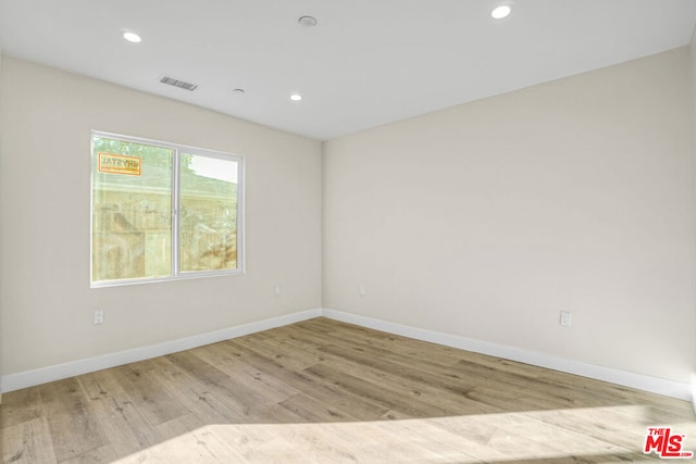 spare room featuring light wood-type flooring