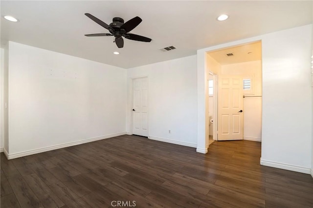 spare room with ceiling fan and dark wood-type flooring