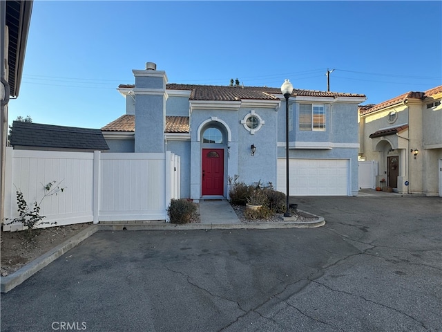 mediterranean / spanish-style home featuring a garage