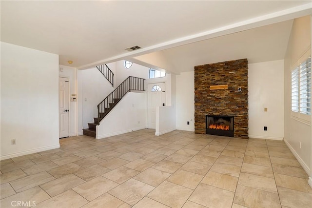 unfurnished living room with a large fireplace