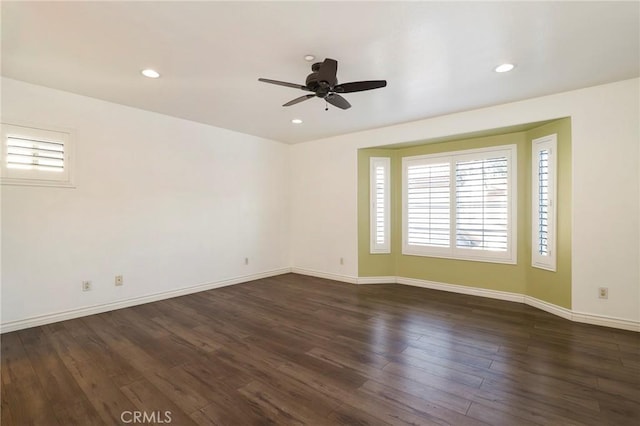 empty room featuring dark hardwood / wood-style floors and ceiling fan