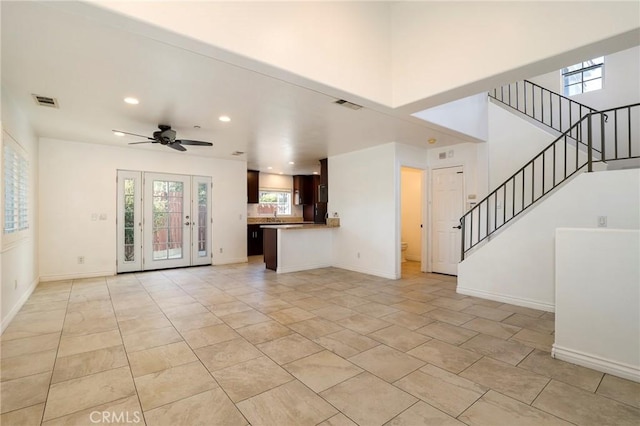 unfurnished living room featuring ceiling fan