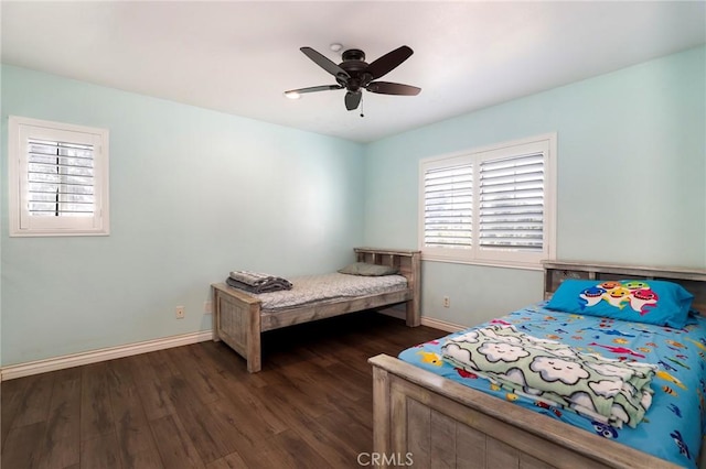 bedroom with dark hardwood / wood-style floors and ceiling fan