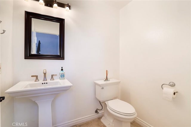 bathroom with tile patterned flooring, toilet, and sink