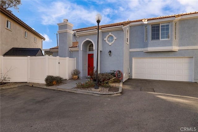 mediterranean / spanish home featuring a garage