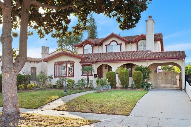 mediterranean / spanish-style house featuring a front lawn