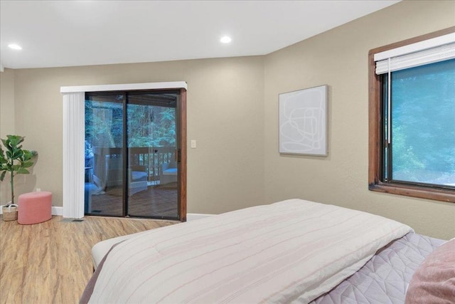 bedroom featuring hardwood / wood-style floors and access to outside