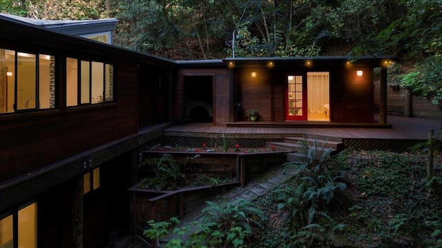 rear view of property featuring a wooden deck