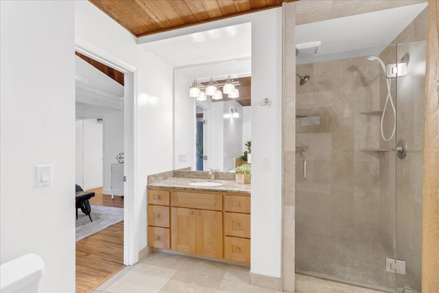 bathroom featuring hardwood / wood-style floors, vanity, walk in shower, and wood ceiling