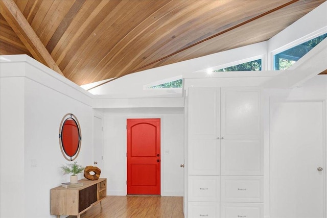 corridor featuring light wood-type flooring, wooden ceiling, a wealth of natural light, and vaulted ceiling