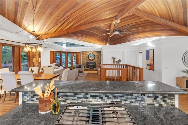 dining area featuring hardwood / wood-style floors, lofted ceiling with beams, plenty of natural light, and wood ceiling