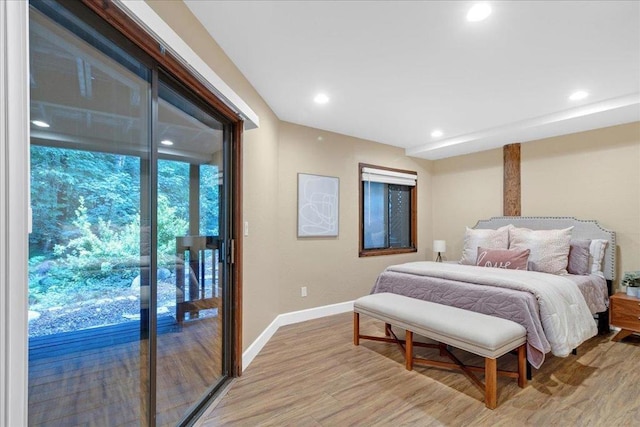 bedroom with access to exterior and light wood-type flooring