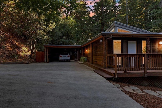 property exterior at dusk featuring a carport