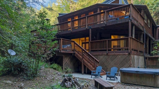 back of house featuring a deck and a patio area