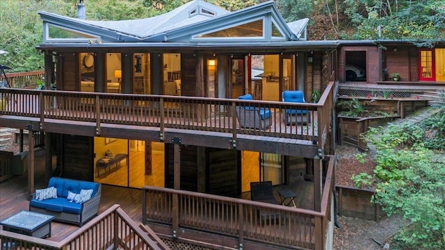 rear view of house featuring outdoor lounge area and a wooden deck