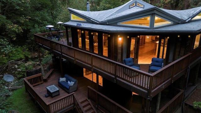 back of house featuring a wooden deck and an outdoor hangout area