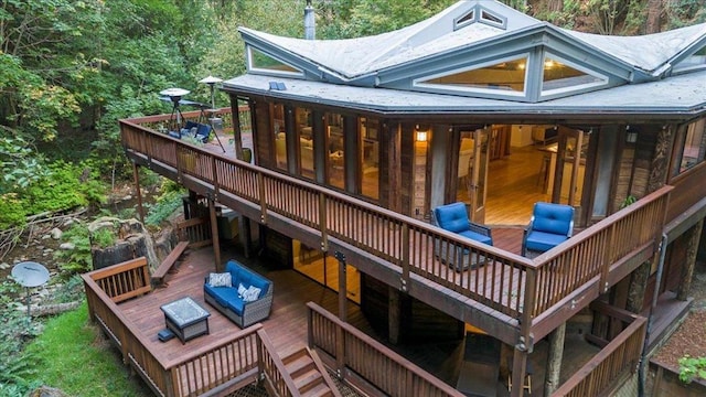 rear view of house with an outdoor living space and a deck