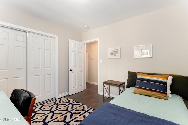 bedroom featuring dark wood-type flooring and a closet